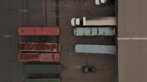 Birds Eye View of Cargo Truck Loading Area with Crates and Containers