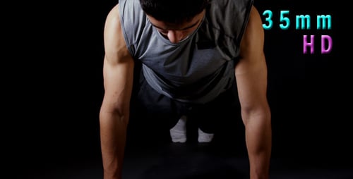 Young Adult Man Doing Push-Ups in Studio
