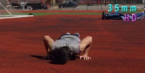 Man Doing Pushups on Red Athletic Track