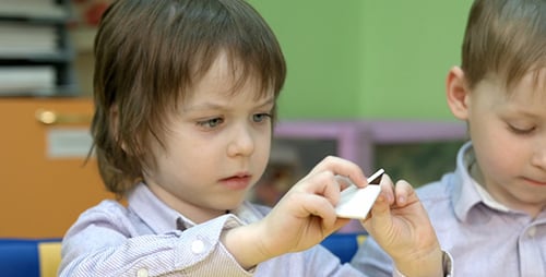 Child Matching Shapes in Classroom Setting