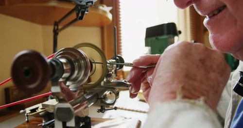 Craftsman working with a cog, metal lathe machine