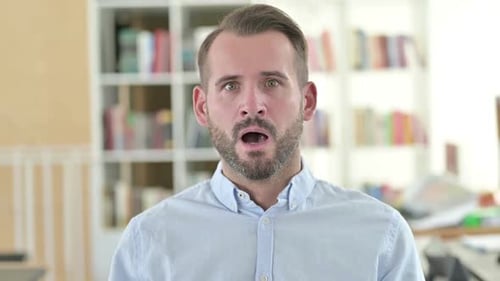 Surprised Man Covers His Mouth with His Hand