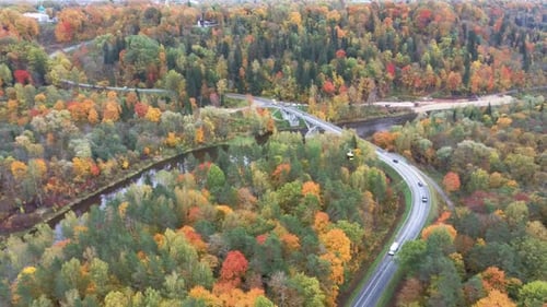 Aerial View of the Sigulda Bridge and Cable Car Over Gauja River During Golden Autumn in Latvia. 4K