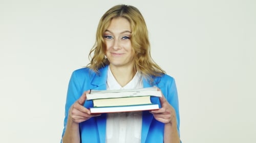 Smiling Woman Holding Books in front of White Background