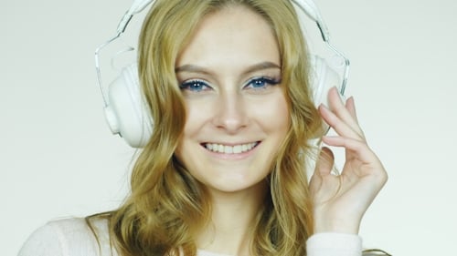 Smiling Woman Listening to Music on Headphones