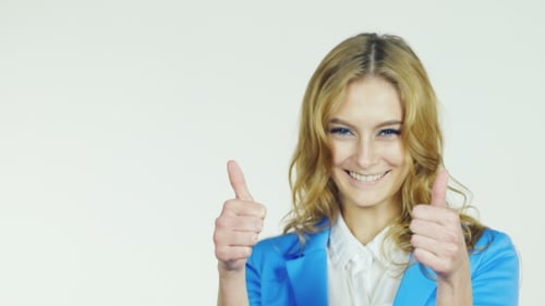 Smiling Woman Gives Thumbs Up Approving Gesture