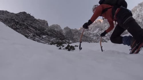 Climbers hike towards the top of a mountain.
