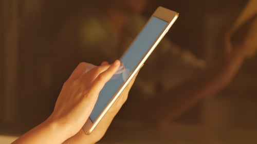 Close Up on Hands Using Touchscreen Tablet