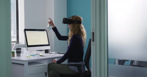 Woman Using VR Headset in Modern Office