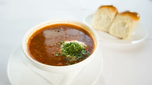 Hearty Soup with Fresh Herbs and Crusty Rolls
