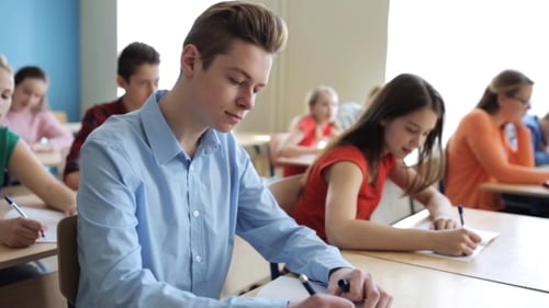 Students With Notebooks Writing Test At School 2