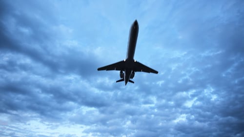 Jet Airplane Flies Through Dramatic Cloudy Sky
