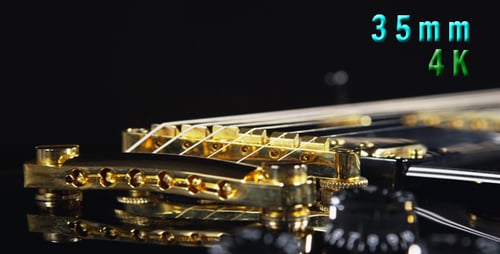 Close Up of Black and Gold Electric Guitar