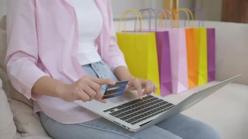 Woman Using Credit Card to Shop Online At Home