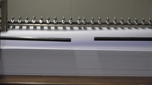 Industrial Machine Processing Stack of White Paper