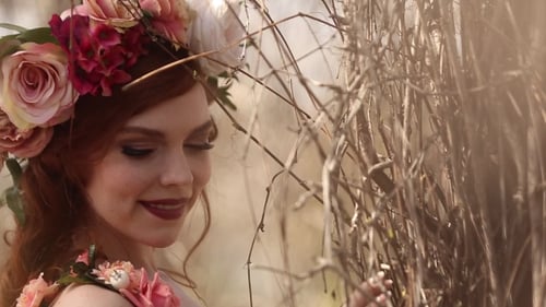 Elegant Woman with Flower Crown Posing Outdoors