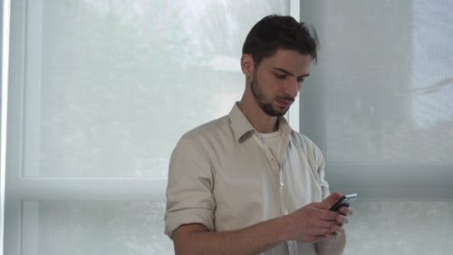 Man Texting Sms On The Mobile Phone