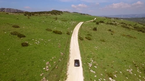 Aerial View Of Driving Car On Hilly Terrain