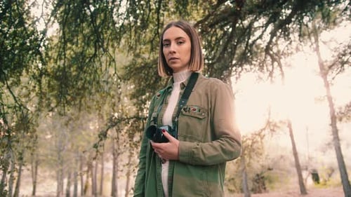 Young Woman with Camera in Forest