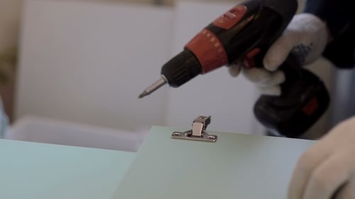 Attaching Hinge to Light Blue Cabinet Panel