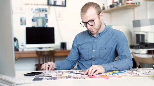 Architect Drawing Floor Plan in Bright Office