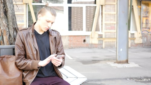 Young Man Using Smartphone