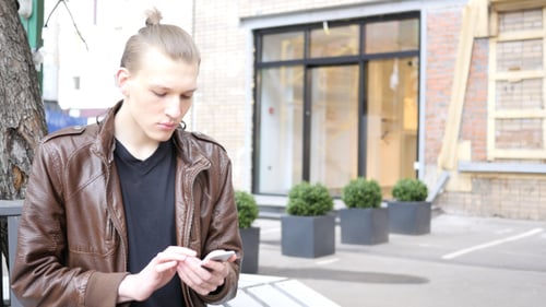 Using Phone while Sitting on Bench