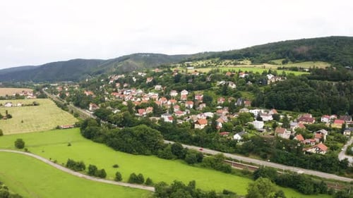 Aerial Drone Shot a Picturesque Town in a Hilly Rural Area Drone Flies in a Curve