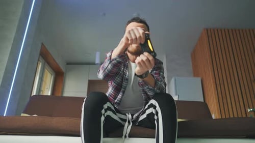 Excited Man Playing Video Game on Couch