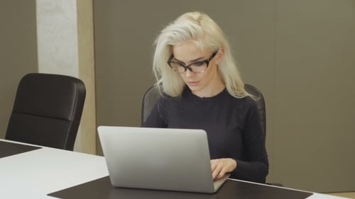 Attractive Young Woman Working In Office Using Laptop