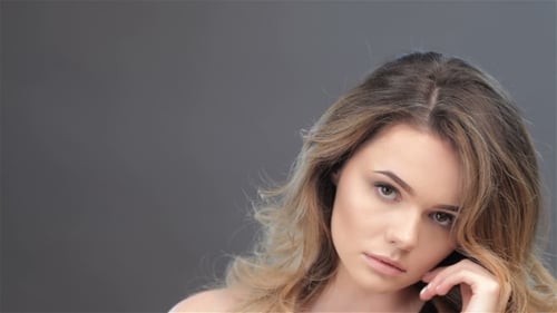 Glamorous Woman Touching Face In Studio Close Up