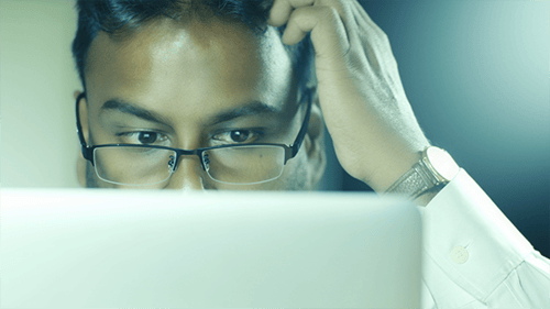 Focused Man Working on Computer Close Up
