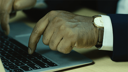 Close up on Man's Hands Typing on Laptop