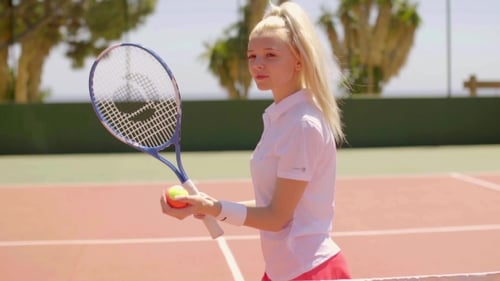 Young Woman Prepares to Play Tennis