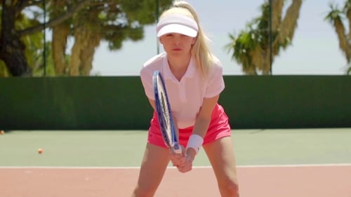 Woman Tennis Player Prepares on Outdoor Court