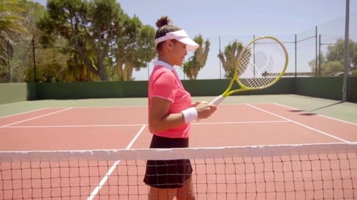Sporty Woman with Racket on Tennis Court