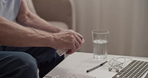 Mature Man Taking Medication Indoors
