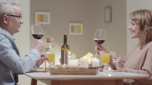 Mature Couple Celebrating Anniversary with Candlelit Dinner