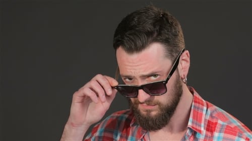 Man with Beard Removes Sunglasses