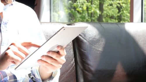 Adult Using Tablet Indoors During Daytime