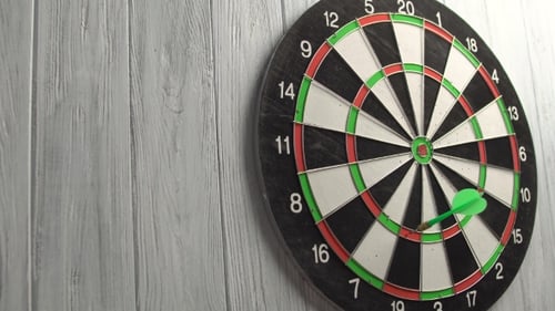 Darts spielen auf weißer Holzwand