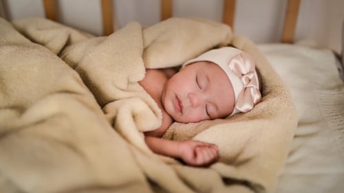 Sweet Infant Sleeping Peacefully in a Cozy Crib