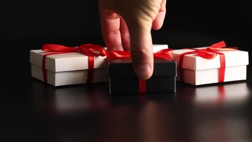 Gift Boxes with Red Ribbon on Black Background