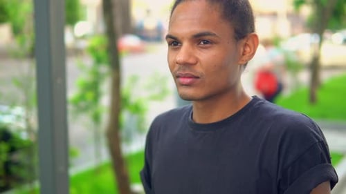 Young Man Drinking Water in Urban Setting