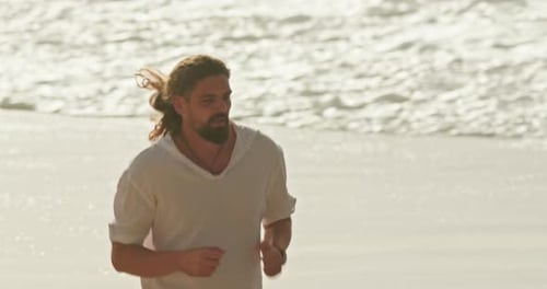 Man Runs on the Beach at Sunrise