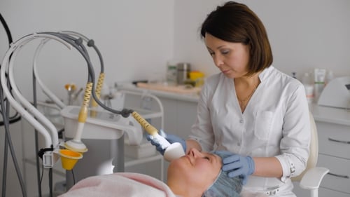 Woman receiving facial skin treatment in clinic