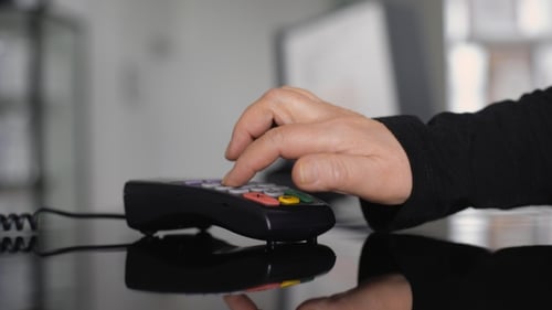 Hand Enters Number on Credit Card Terminal