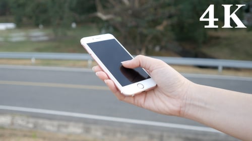 Hand Taps Cell Phone Screen Outdoors Close Up