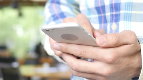 Close Up of Hands Using Mobile Phone