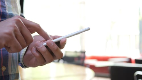 Adult Using a Smartphone Indoors, Close-Up